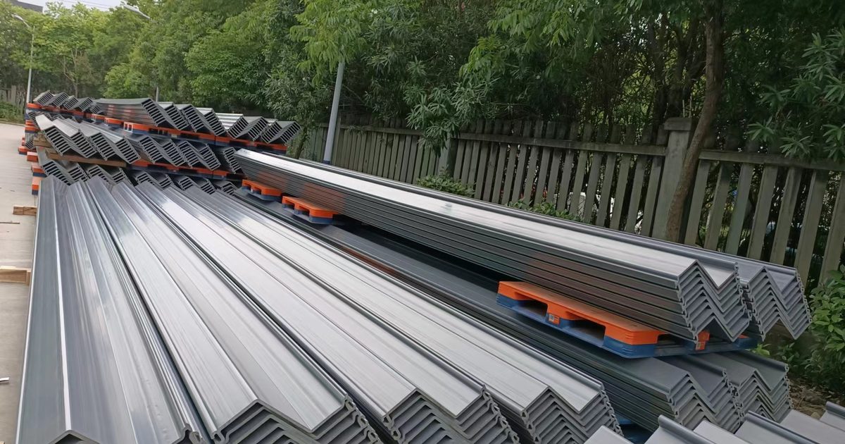 Real gray Z-profile PVC sheet piles stacked in separated bundles, with profile ends visible for delivery inspection.