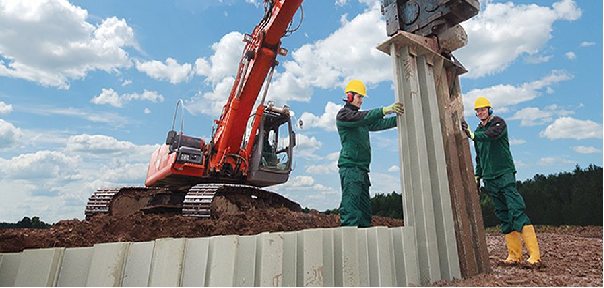 PVC sheet pile wall following the edge of a pond channel with water and vegetation beside the installation.
