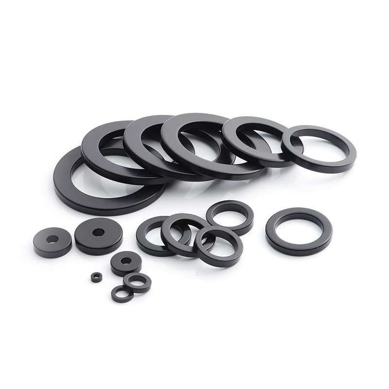Three nickel-plated neodymium ring magnets arranged separately on a clean white background.