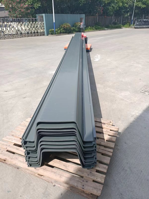 Gray PVC sheet pile wall being installed along an earthwork boundary with the interlocking profiles visible.