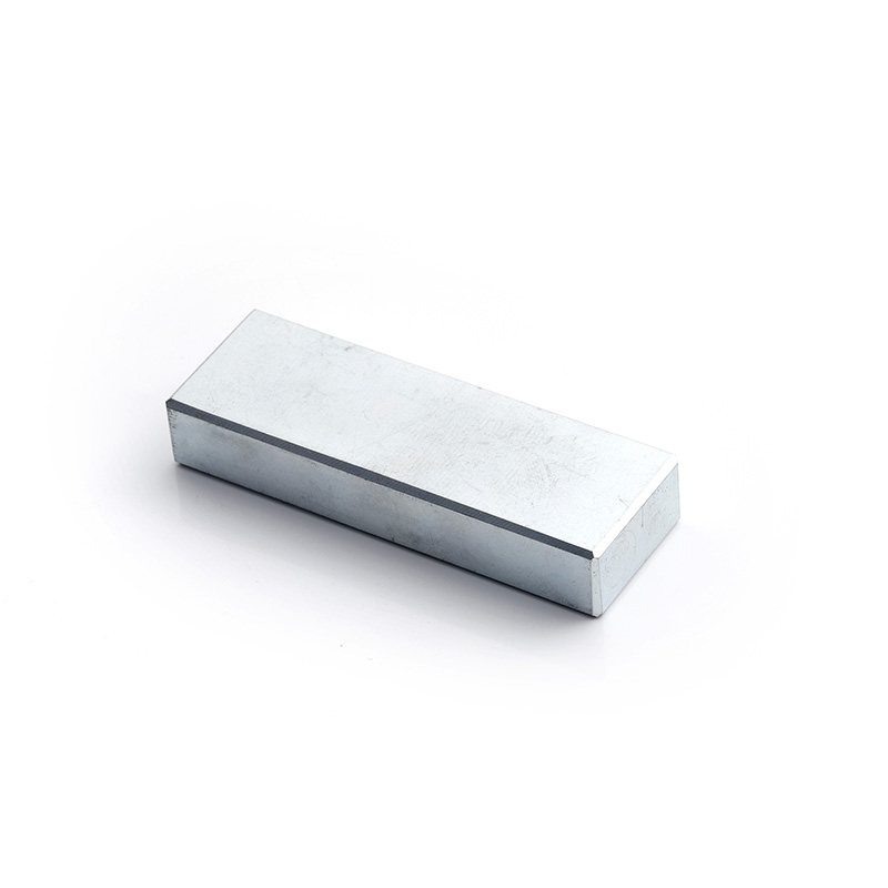 Nickel-plated neodymium block magnets in several rectangular sizes arranged on a white background.