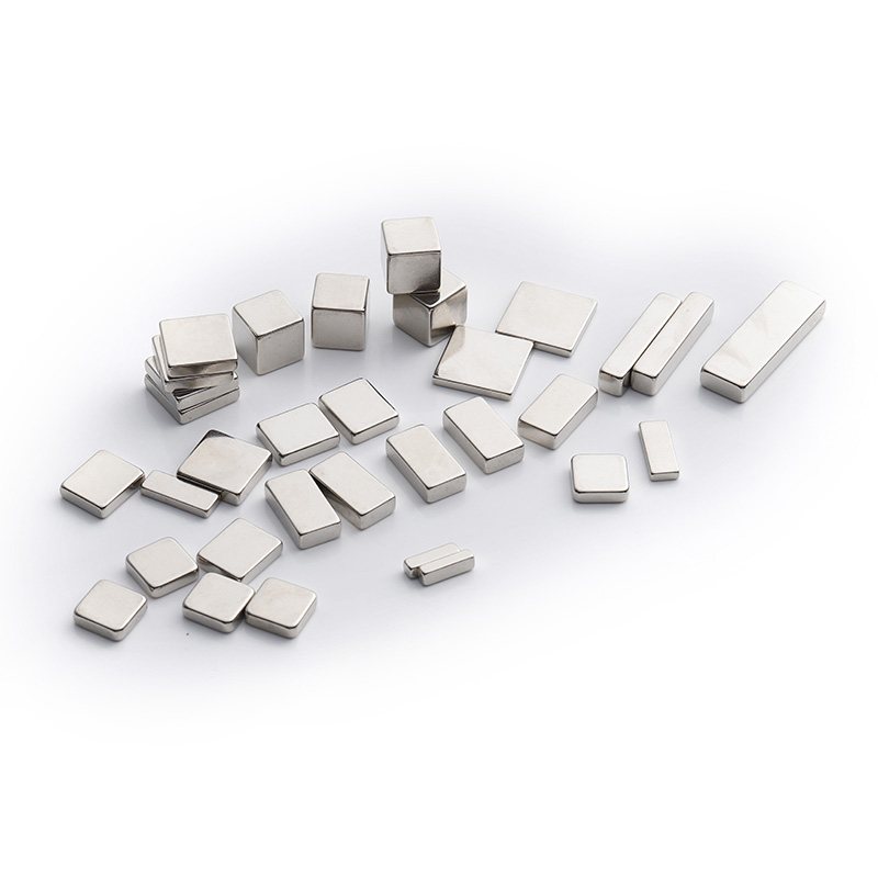 Nickel-plated cylindrical neodymium magnets in several diameters and lengths arranged on a white background.