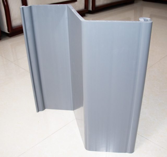 Two grey PVC sheet pile profile samples connected on a tiled floor Two grey PVC sheet pile profile samples connected on a tiled floor