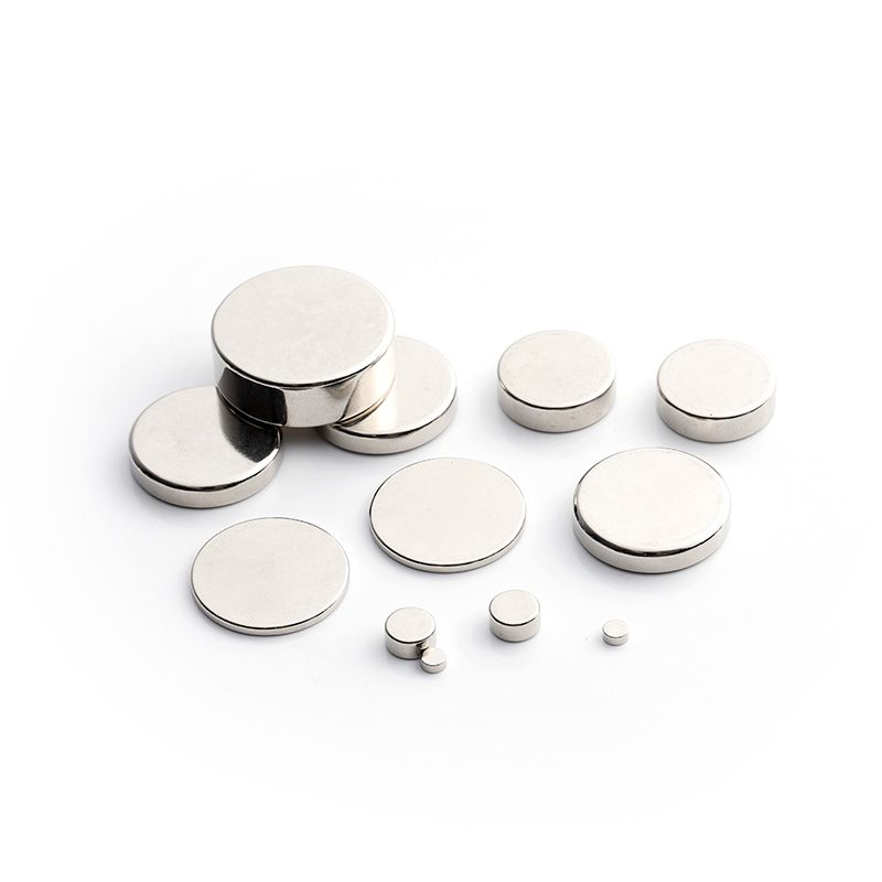 Small nickel-plated neodymium block magnets in assorted shapes on a white background Small nickel-plated neodymium block magnets in assorted shapes on a white background